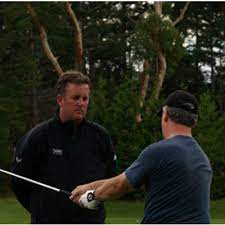 John Randle coaching a student at Country Hills Golf Club
